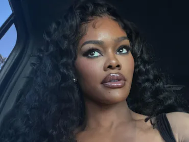 Teyana Taylor in a car, with long, flowing hair