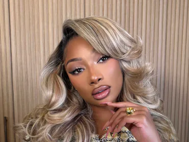 Megan Thee Stallion with blonde hair and pretty glam makeup