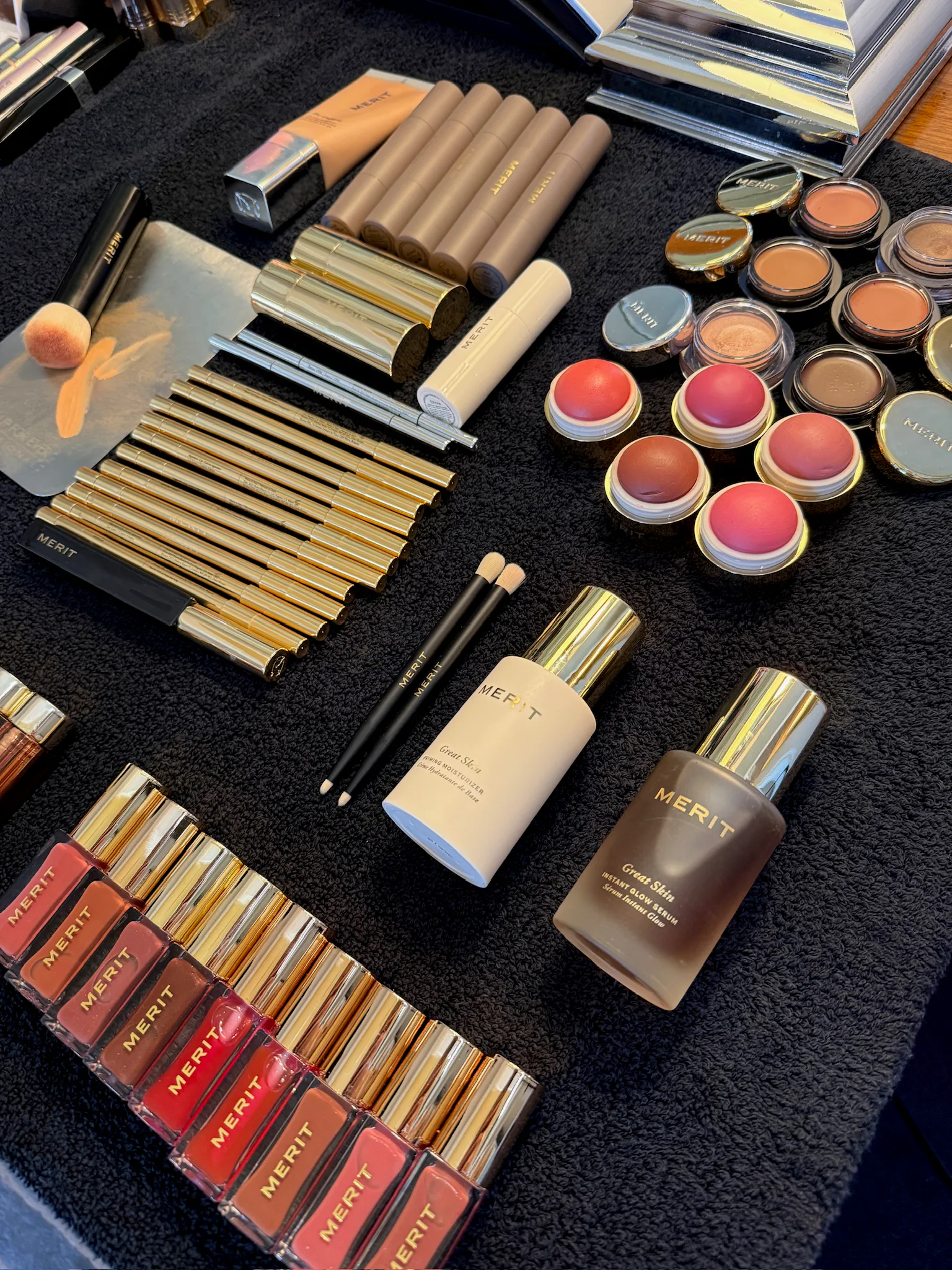 Flat lay of Merit Beauty products used on Misty Copeland