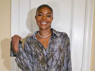 Gabrielle Union, standing in front of a door smiling