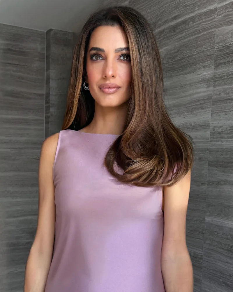 Amal Clooney with her new "bell-bottom" haircut, wearing a lilac prada dress