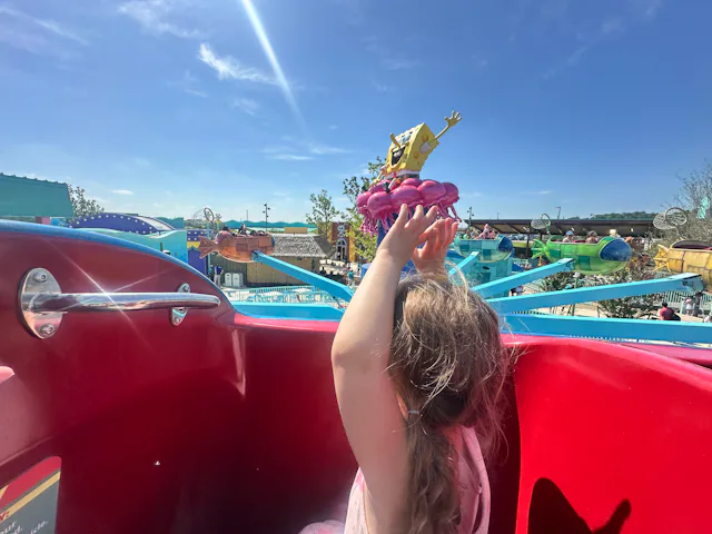 A little girl rides a ride at the new Universal Kids Resort in Texas