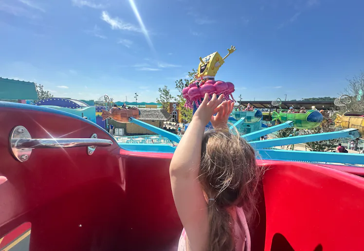 A little girl rides a ride at the new Universal Kids Resort in Texas
