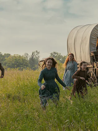Netflix's Little House in the Prairie screen grab of the ingalls family running through a field.