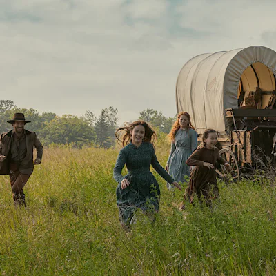 Netflix's Little House in the Prairie screen grab of the ingalls family running through a field.
