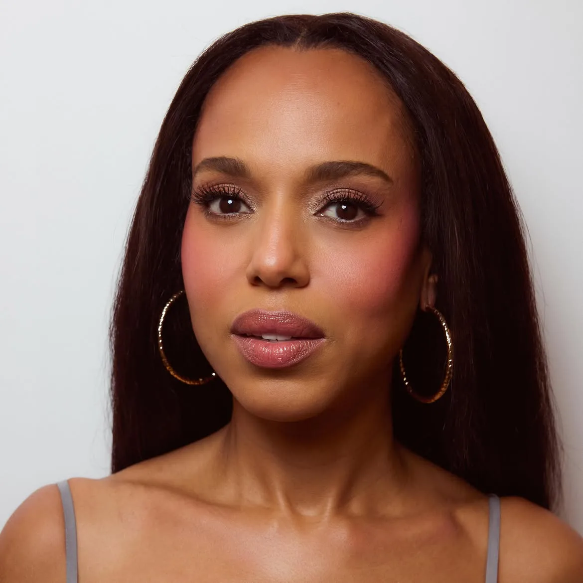 Kerry Washington wearing bright pink blush with straight hair