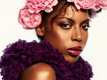 True Whitaker in flower head piece and purple dress