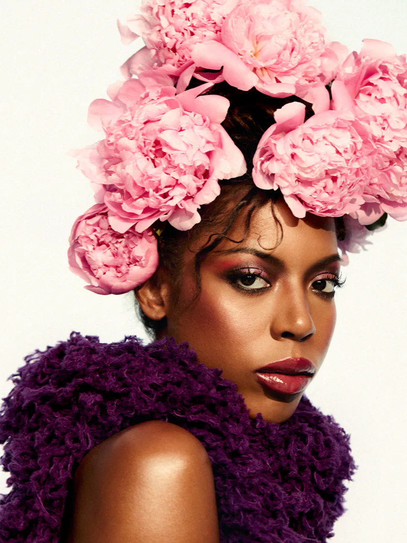 True Whitaker in flower head piece and purple dress