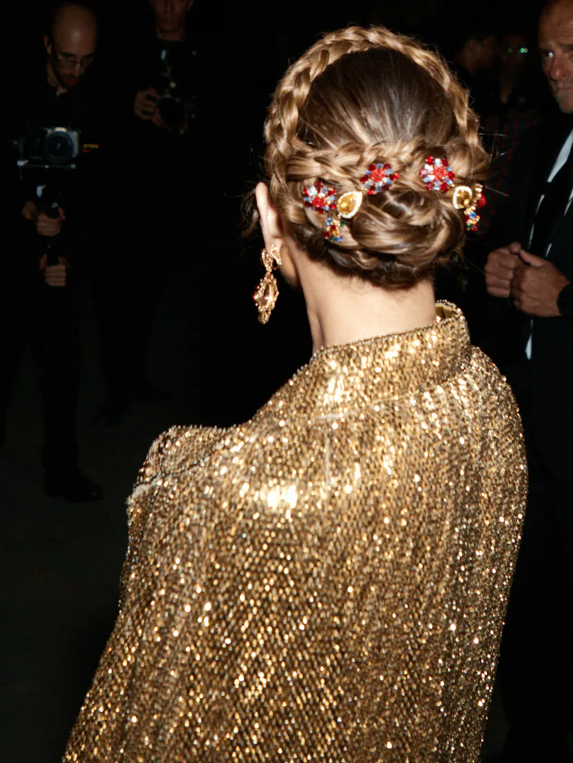 The back of Jennifer Lopez's head, her hair in a halo braid with brooches throughout