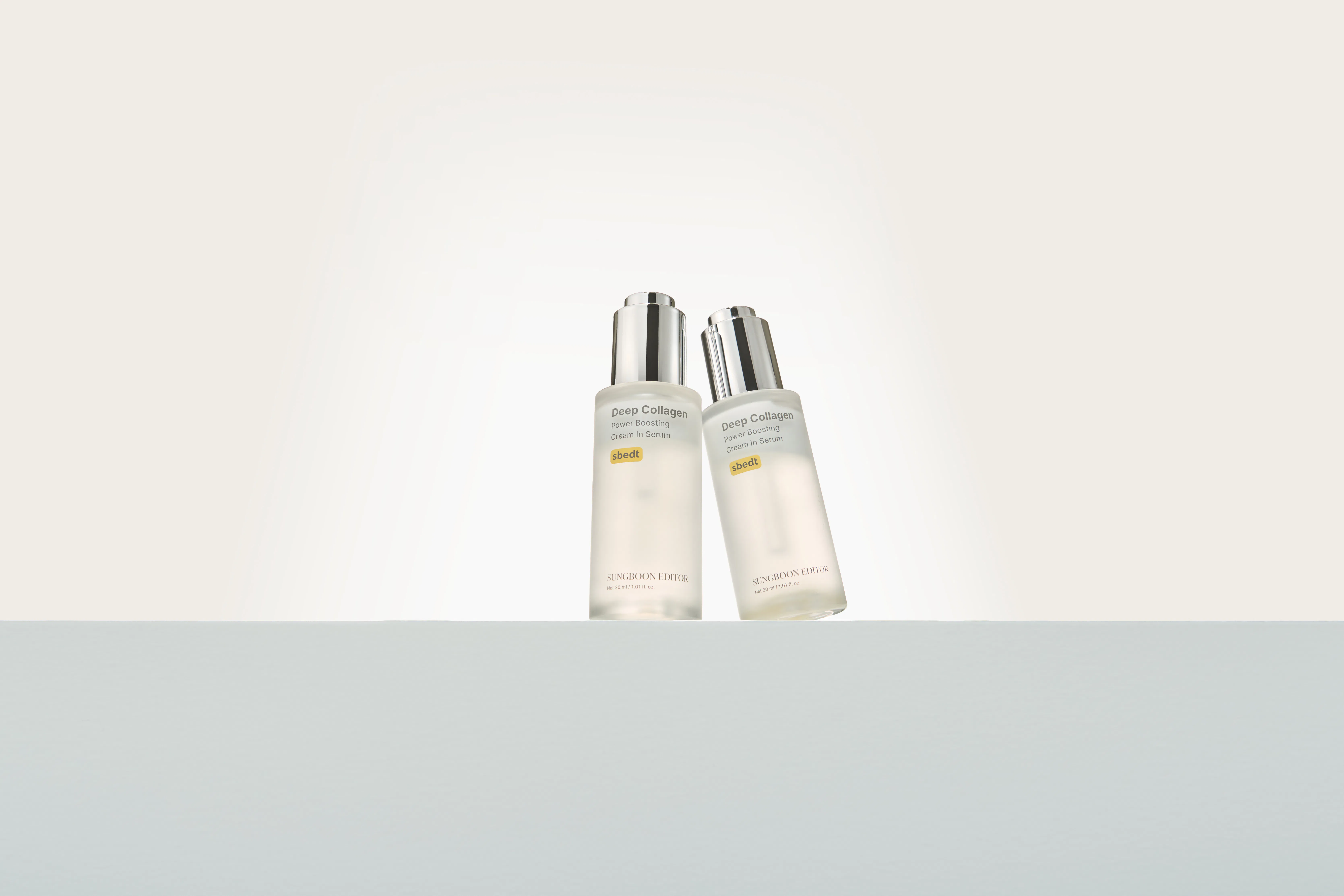 Two bottles of Sungboon Editor's Deep Collagen Power Boosting Cream In Serum, which contains Volufil...
