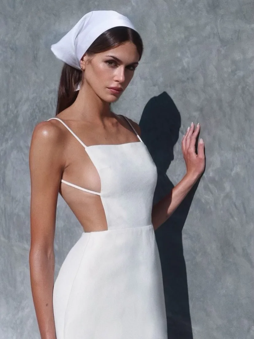 Kaia Gerber with her hair tied back with a white scarf