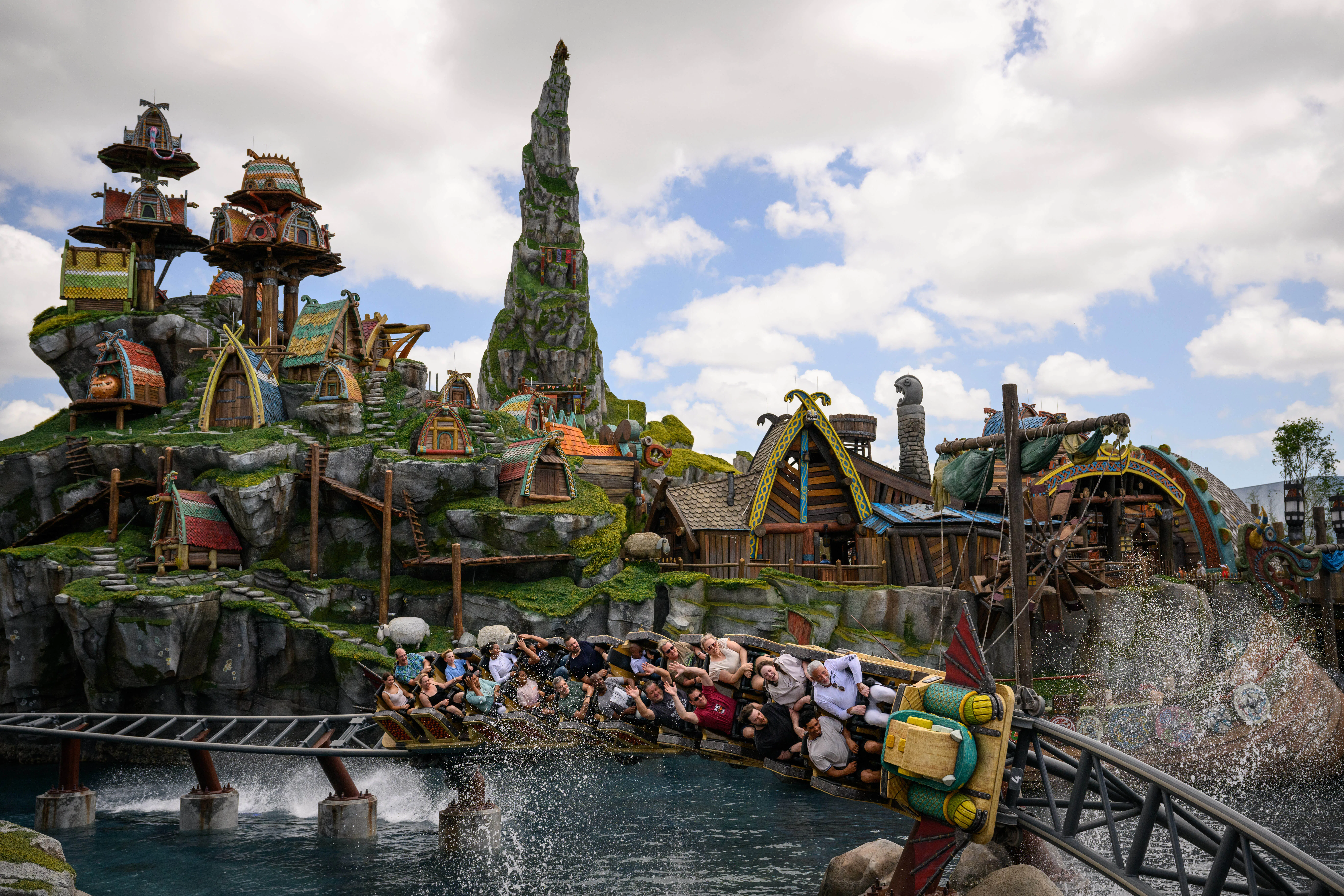 Guests ride the Hiccup's Wing Gliders rollercoaster in the How to Train Your Dragon - Isle of Berk a...