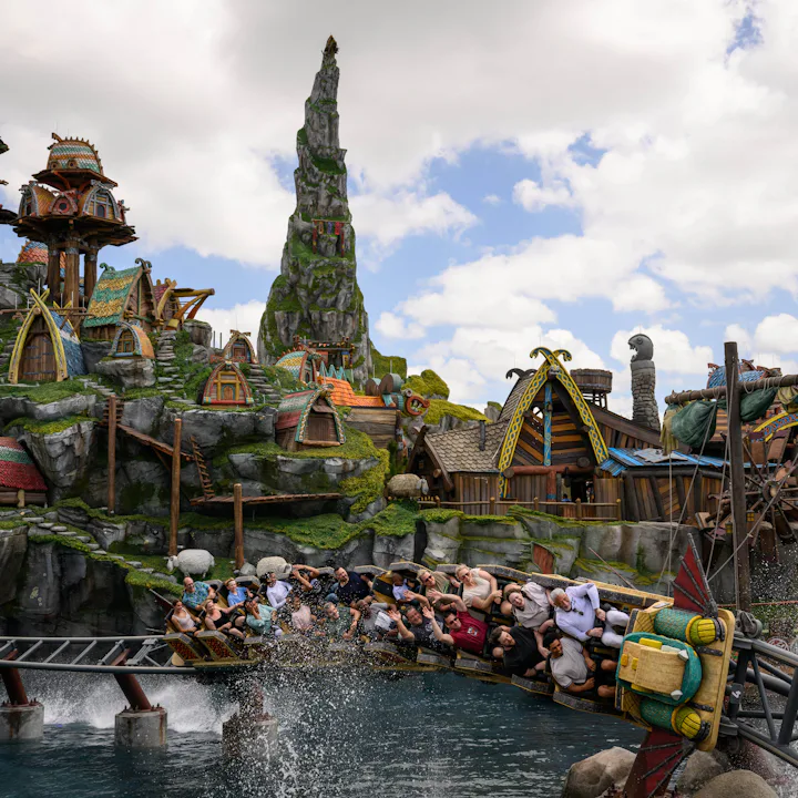 Guests ride the Hiccup's Wing Gliders rollercoaster in the How to Train Your Dragon - Isle of Berk a...