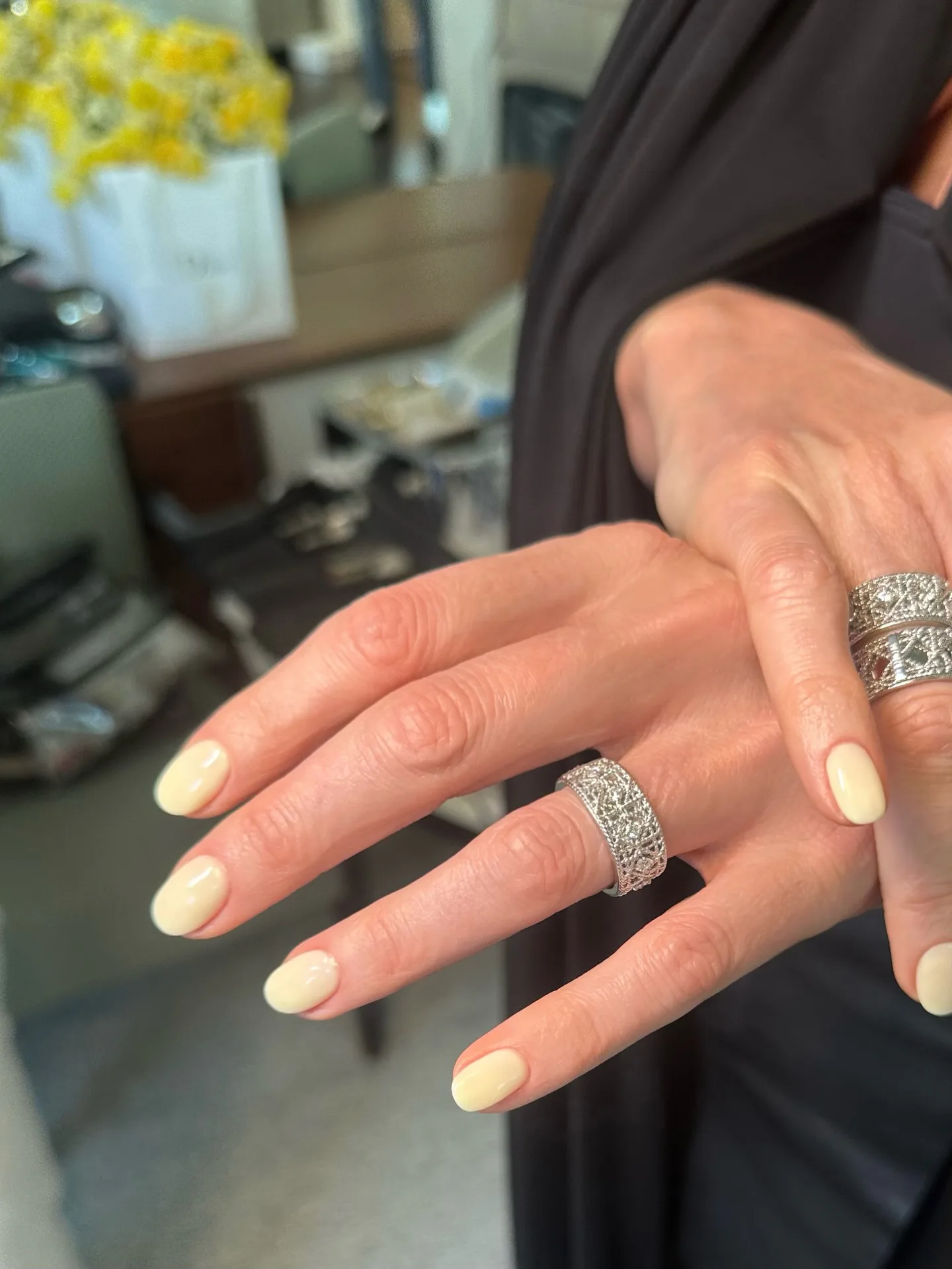 A butter yellow manicure on Charlize Theron