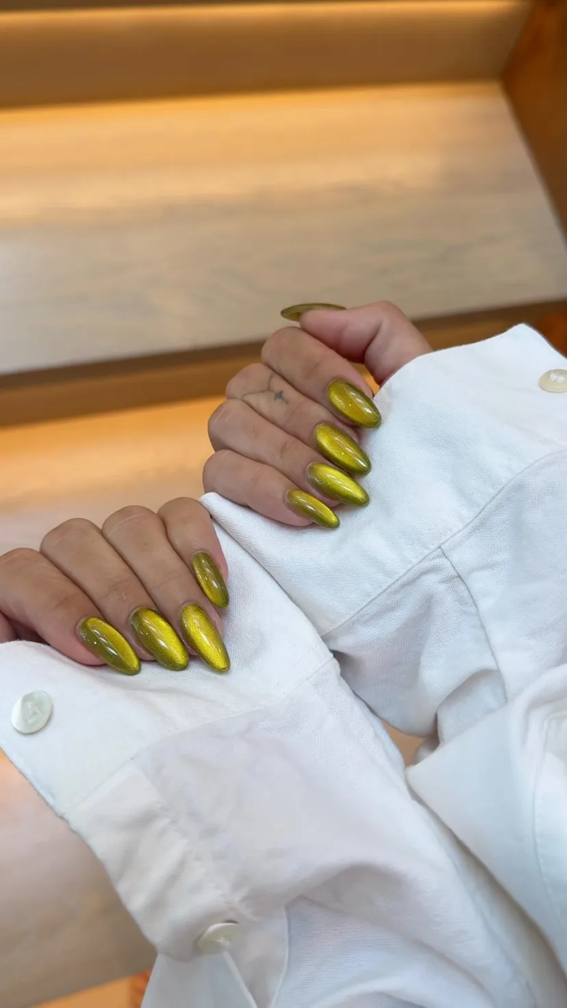 a pickle green manicure on Vanessa Hudgens' hands