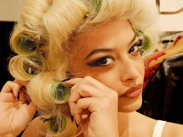 Devyn Garcia photographed by Anthony Seklaoui unrolling curlers from her hair