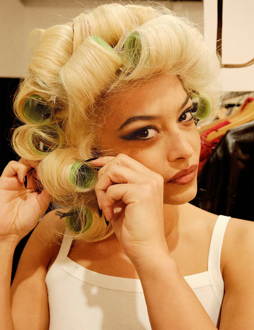 Devyn Garcia photographed by Anthony Seklaoui unrolling curlers from her hair
