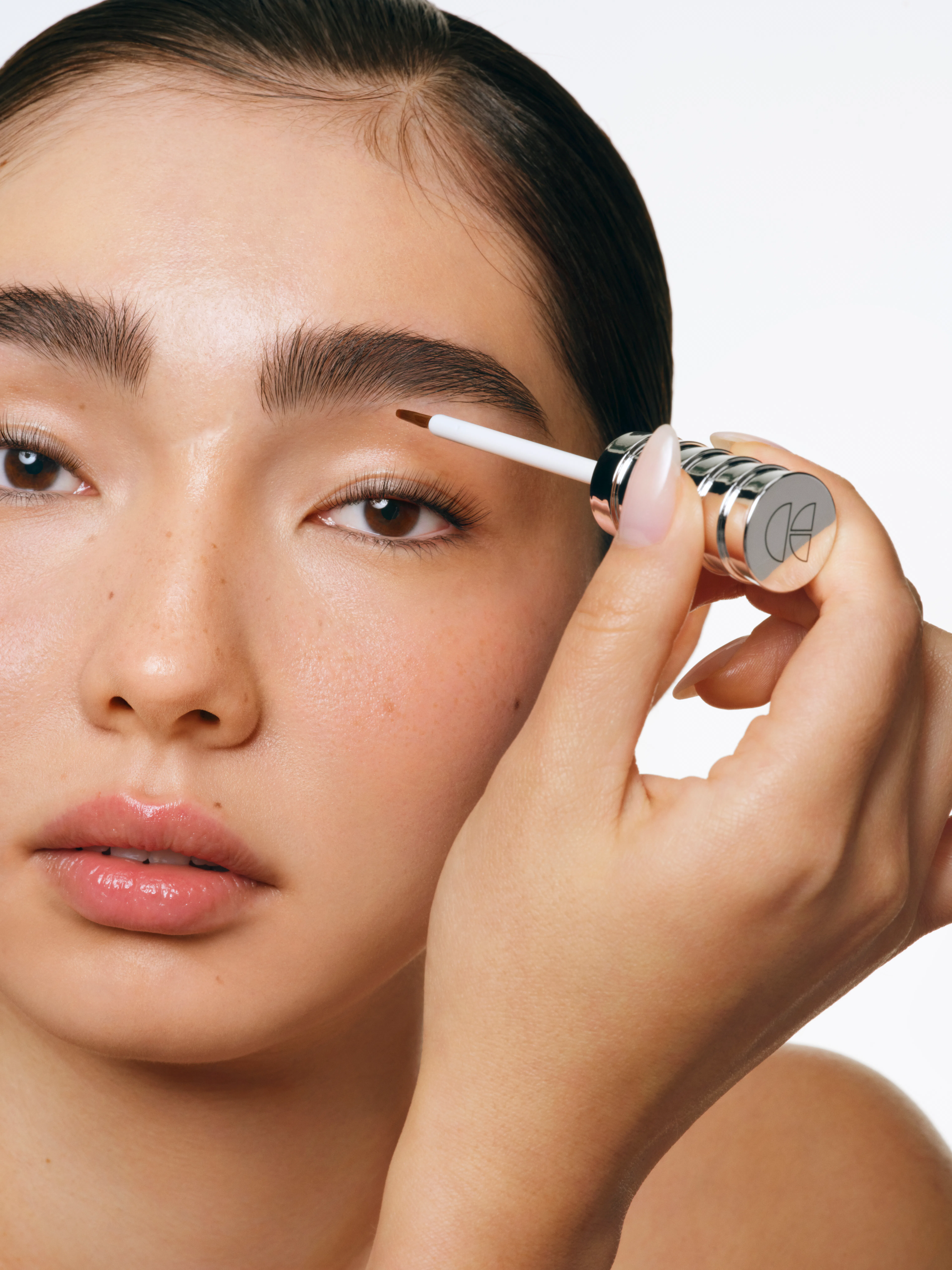 A model applies the Cécred Restoring Lash & Brow Builder