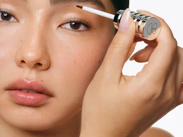 A model applies the Cécred Restoring Lash & Brow Builder