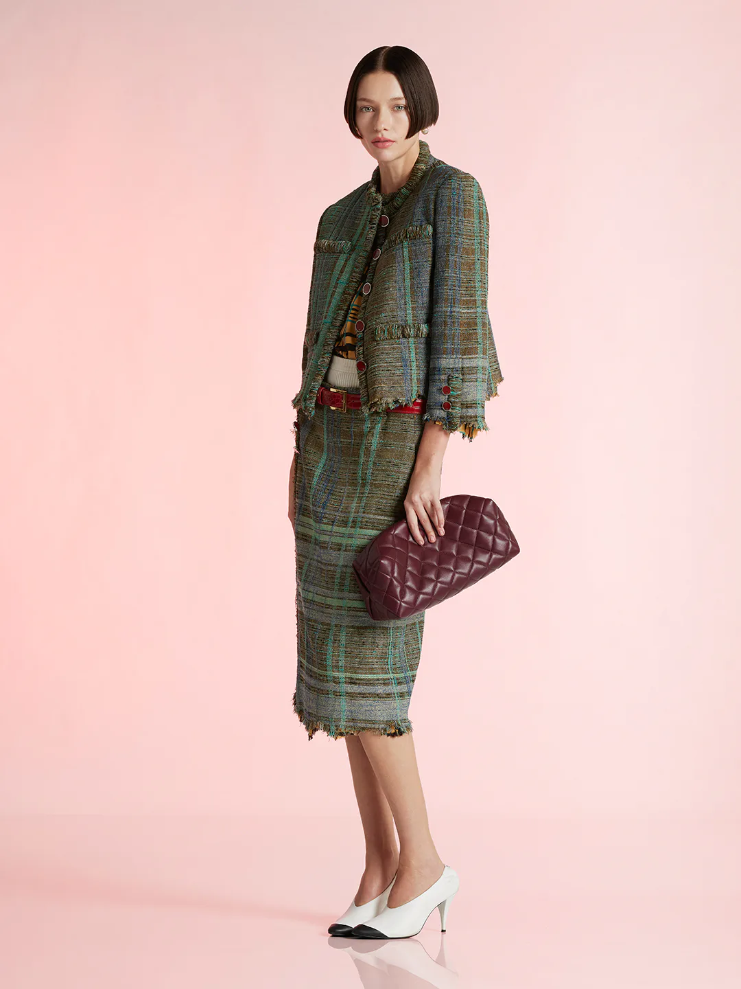 A model wearing a jacket/matching skirt