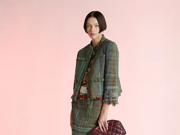 A model wearing a jacket/matching skirt