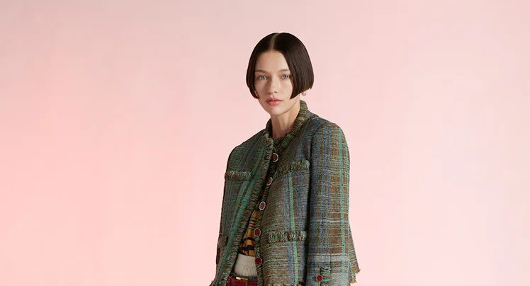 A model wearing a jacket/matching skirt