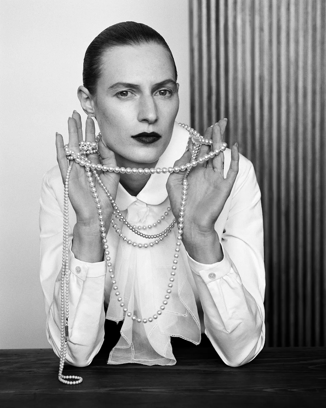 Black and white picture of Julia Nobis wearing pearls