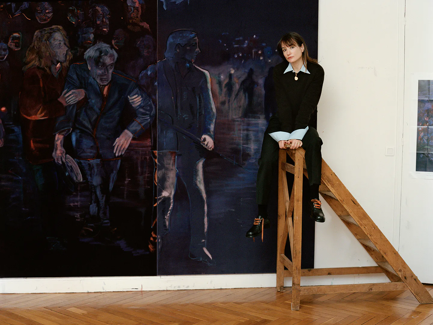 The artist Jill Mulleady on a ladder with her painting 'The Passenger.'