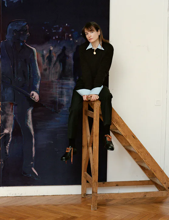 The artist Jill Mulleady on a ladder with her painting 'The Passenger.'