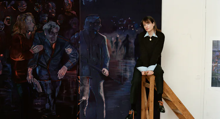 The artist Jill Mulleady on a ladder with her painting 'The Passenger.'