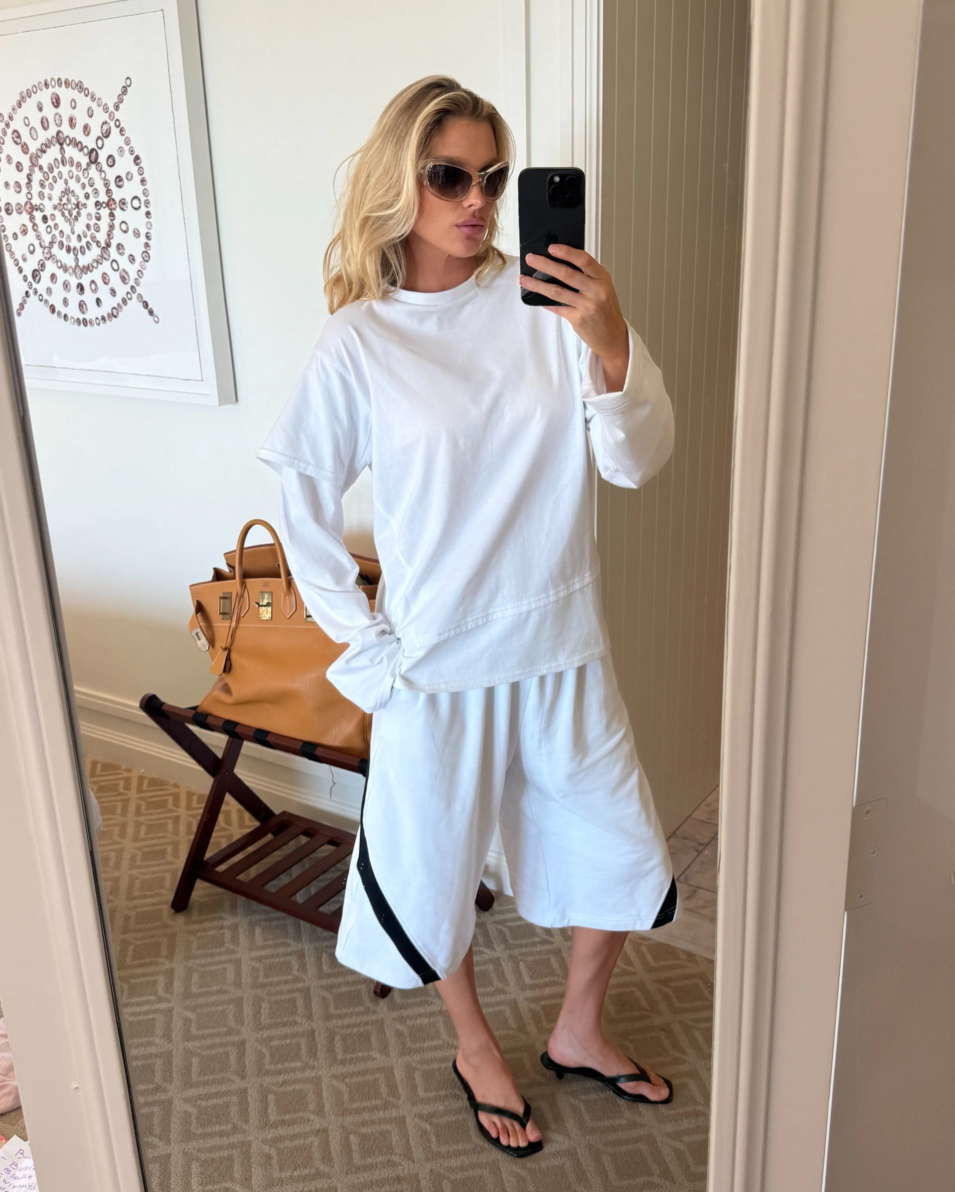 Elsa Hosk wears the "emo-core" tee over long-sleeved shirt. 