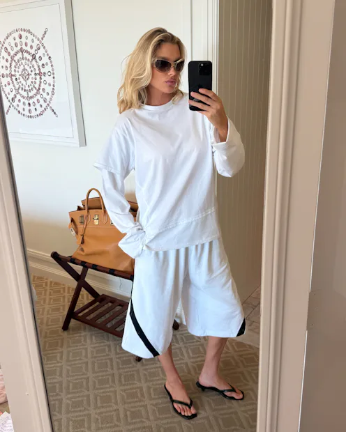 Elsa Hosk wears the "emo-core" tee over long-sleeved shirt.
