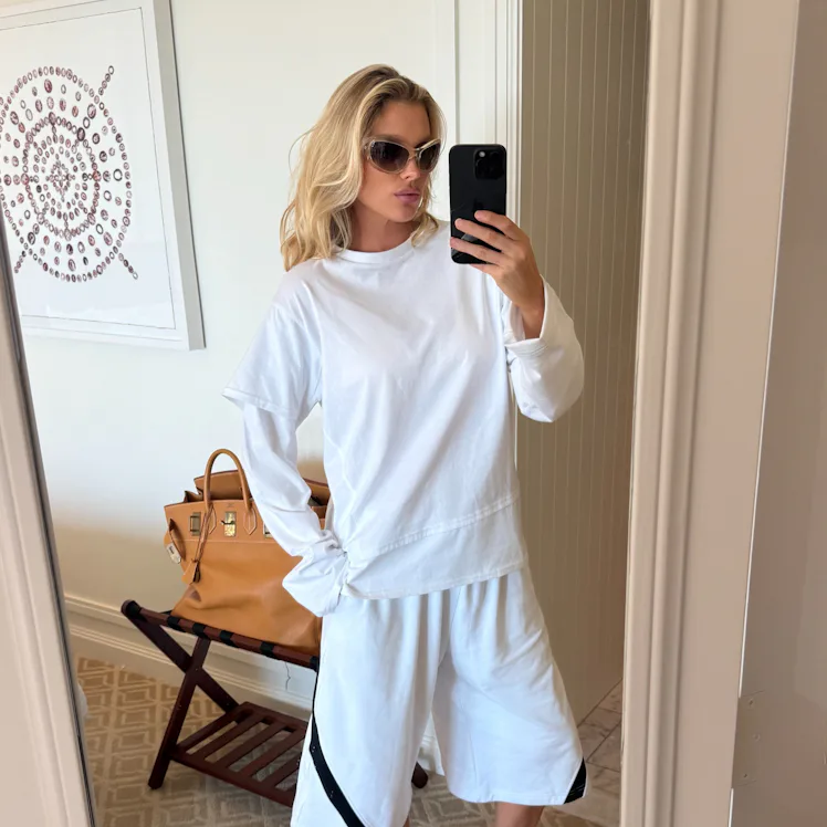 Elsa Hosk wears the "emo-core" tee over long-sleeved shirt.