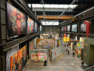 AMSTERDAM, NETHERLANDS - DECEMBER 11: General view of people looks the graffiti art inside the STRAA...