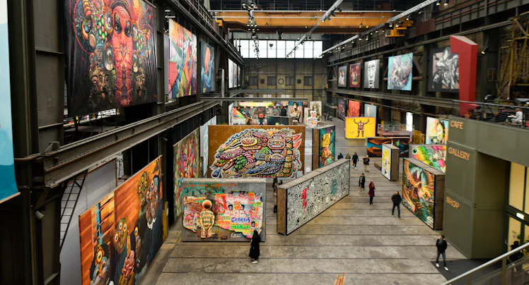 AMSTERDAM, NETHERLANDS - DECEMBER 11: General view of people looks the graffiti art inside the STRAA...