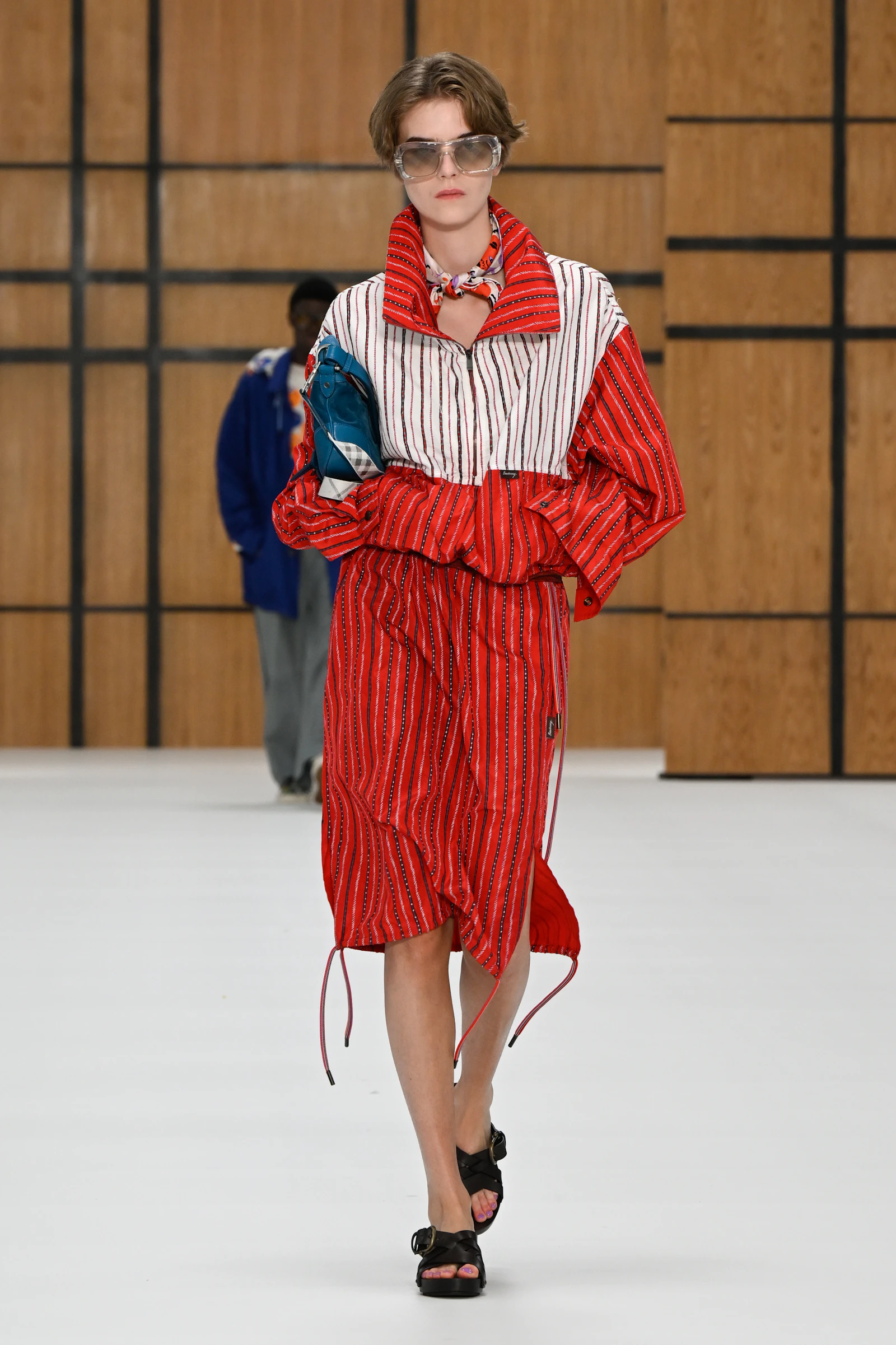 Model in a red striped Burberry skirt and jacket with an oversized gathered collar