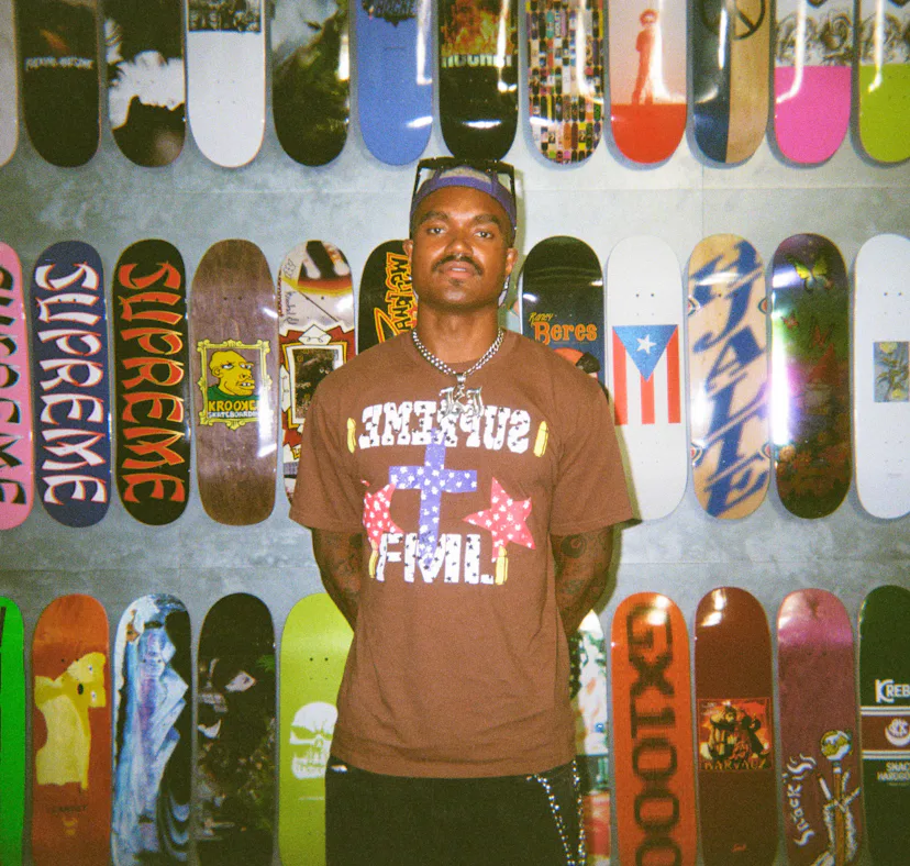 'Summer House' star KJ Dillard posing in front of skateboards.