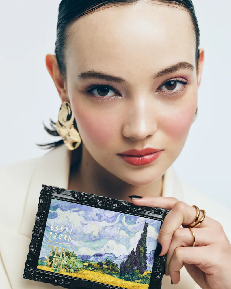 A model holding an eyeshadow palette from the Bobbi Brown x The Met collection