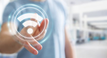 Businessman on blurred background using free wifi hotspot interface 3D rendering