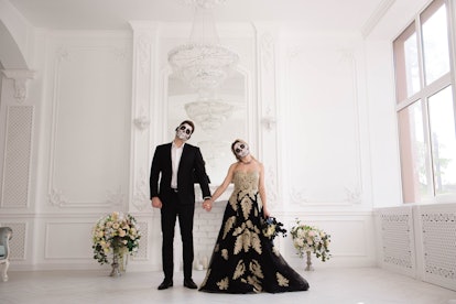 A wedding couple with skeleton make up for Halloween or All Souls Day