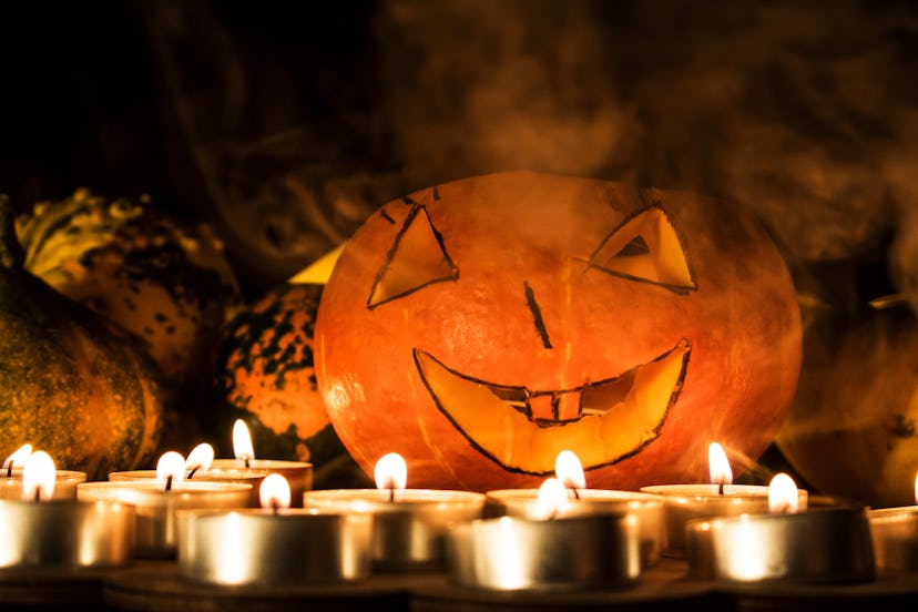 Halloween pumpkin in smoke. Smiling pumpkin for Halloween.