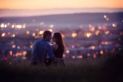 Lovers man and girl against background night city, night starry sky and horizon. Concept date Valent...
