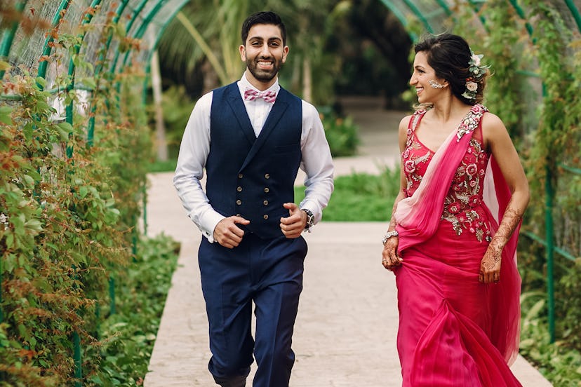 Indian newlyweds run under green arch in the garden. If you're alcohol-free, weddings can be challen...