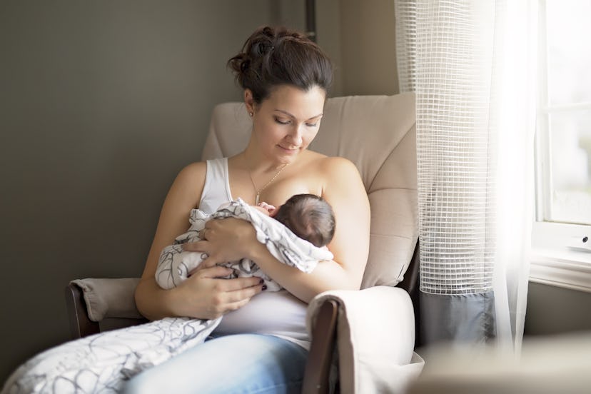 A Mother breastfeeding her little baby boy in her arms.