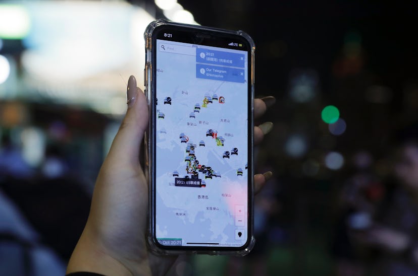 A person's phone shows HKmap.live apps as they join others at a rally to mark Taiwan's National Day,...