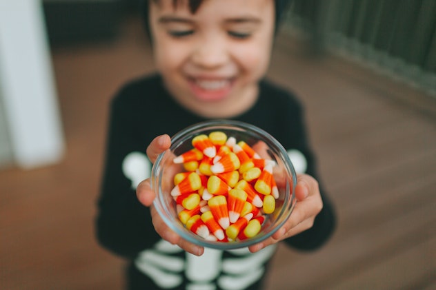 A little boy holding halloween candy.
