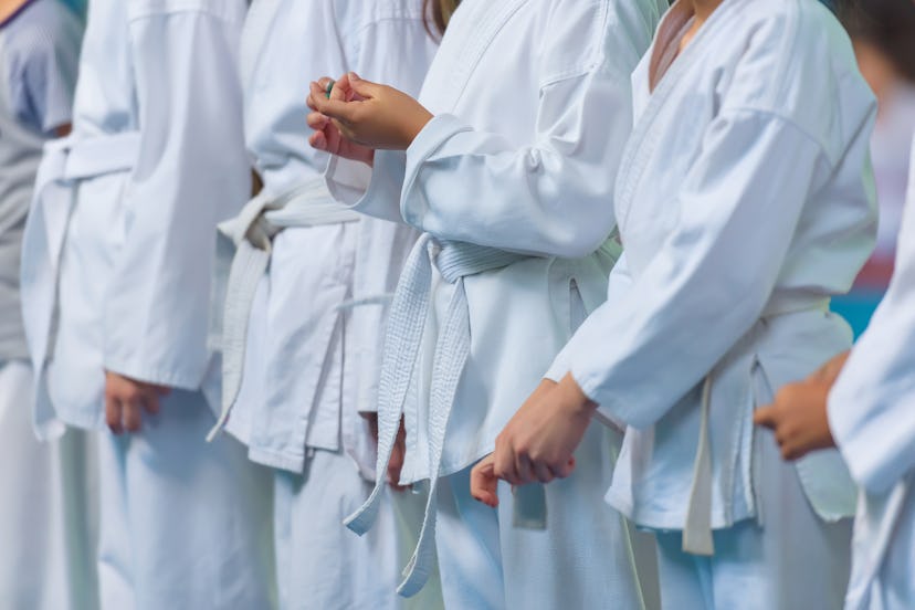 Children in a kimono on tatami. Classes in karate on mats