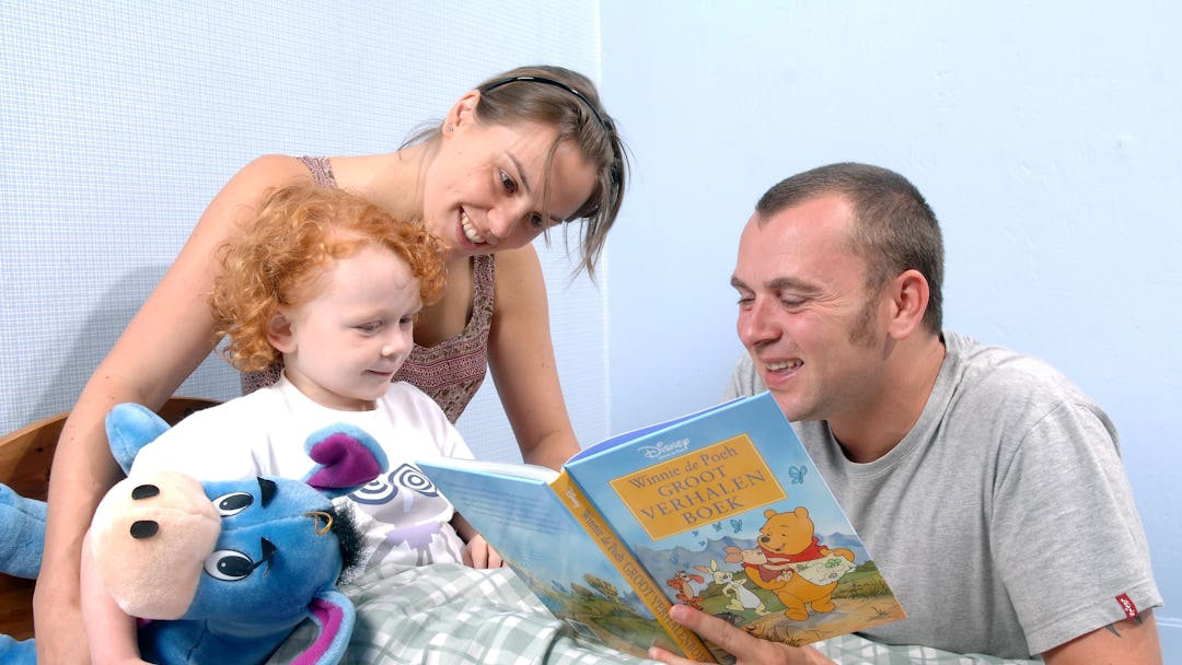 Model released - Parents reading child a bedtime story