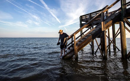 Visiting the area for the first time, 64-year-old Fran Glod of Oswego, N.Y, walks down the steps to ...