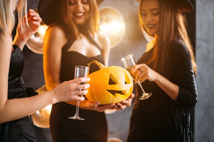 In good moods at halloween party. womans with pumpkins